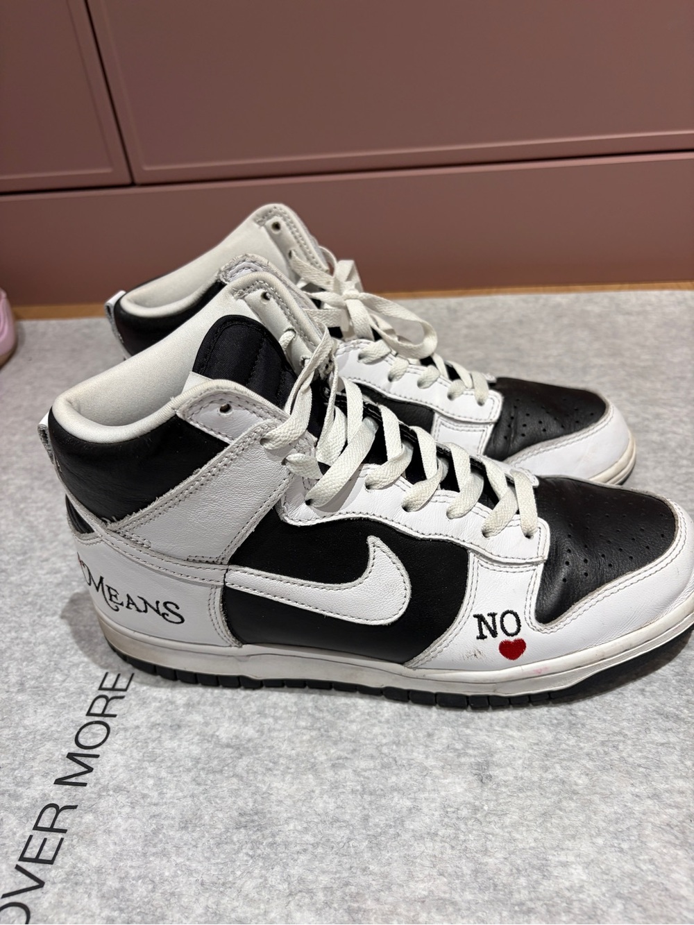 Supreme Black and White High-Top Sneakers with Red Heart Accent